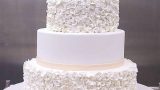 Wedding cake size XL covered with ruffle flowers and little bow ribbon